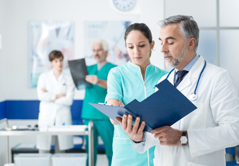 Doctor and nurse examining medical records