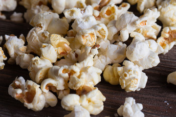 Popcorn on wooden table, close up