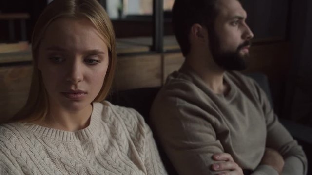 Love keeping us alive. Close up of young pleasant couple sitting closely while hugging each other and recovering relationships