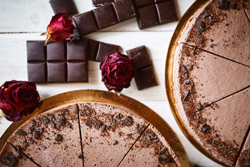 Chocolate mousse cheesecakes with a sprinkle of grated chocolate on a wooden table