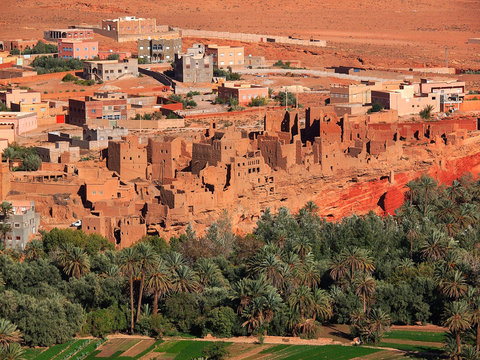 The ancient moroccan town near Tinghir consisting of the clay made adobe kasbahs in front of gorgeous brown high Atlas mountains (Gorge du Dades) - Africa, Morocco - View point