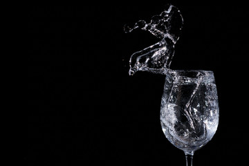 Water splash in a glass on a black background