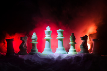 Chess in the snow. winter concept. Christmas or New Year present on a chessboard with Santa Claus on a dark background. Copy space.