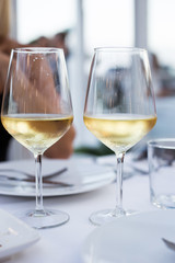 Two glass of white wine standing on the table
