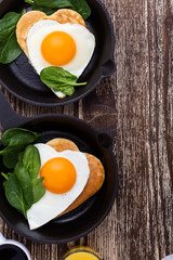 Valentine's day breakfast or brunch with  heart shape fried egg in cast iron skillet