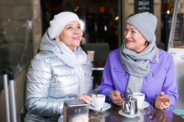 Fototapeta na wymiar Two happy senior women at terrace cafe