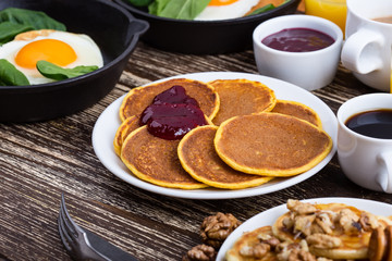 Valentine's day breakfast  with  heart shape fried egg in cast iron skillet and pancakes
