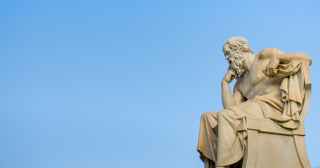 Ancient marble statue of the great Greek philosopher Socrates on background the blue sky. 