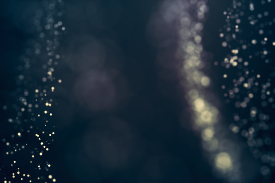Glitter lights defocused background. Bokeh dark illustration