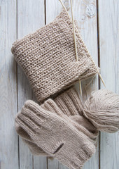 Fototapeta na wymiar grey knitting on wooden surface