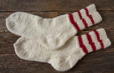 knitted warm socks on wooden surface