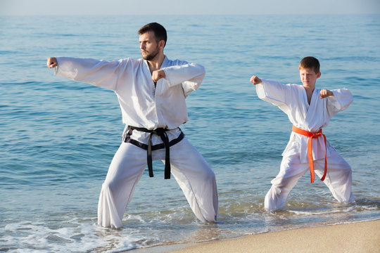 Man and boy practising karate