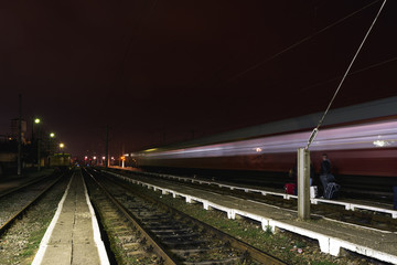 Train passing by a rural railway station in Arad, Romania