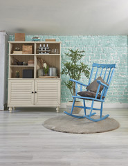 turquoise background cabinet and blue swing chair decoration