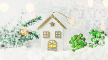 toy decoration house made of wood on white snow