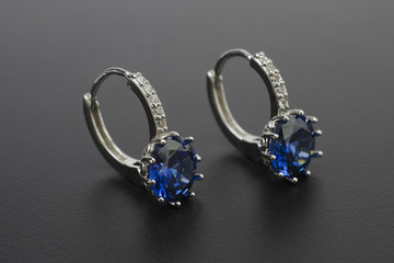 silver earrings with diamonds and sapphires isolated on black