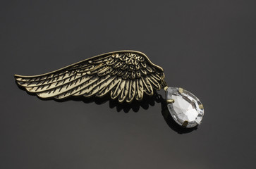 brooch wing with diamond isolated on black