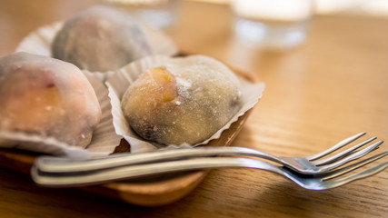 Fruit Mochi on a wooden plate with steel forks