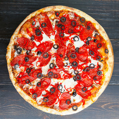 fresh and delicious Italian pizza on a wooden table