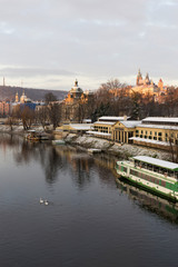 Early Morning Christmas snowy Prague Lesser Town with gothic Castle above River Vltava, Czech republic