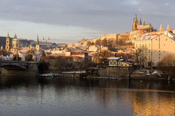 Naklejka na ściany i meble Early Morning Christmas snowy Prague Lesser Town with gothic Castle above River Vltava, Czech republic