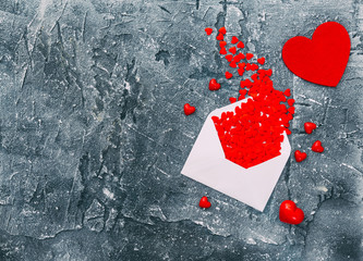 valentine's day concept: envelope with a lot of little red hearts.