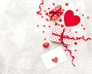 Valentine day love letter. Envelope with red hearts heap spread on vintage background. Lover's holiday confession or proposal concept