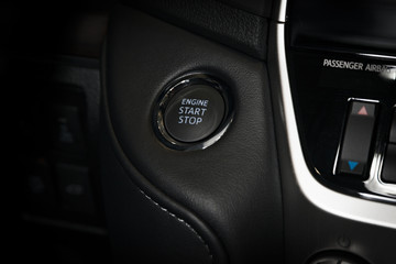 Engine start stop button in a modern luxury car interior