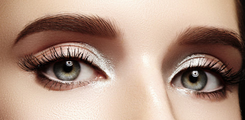 Closeup female eyes with bright make-up, great shapes brows, extreme long eyelashes. Celebrate makeup, luxury eyeshadows - obrazy, fototapety, plakaty