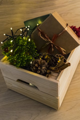 Christmas decorations in a wooden box on a wooden table