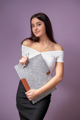 Young female model College student.girl posing with a folder in hands