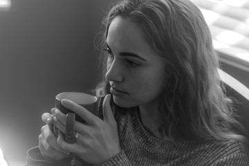 Black and white portrait young female drinking coffee in the morning