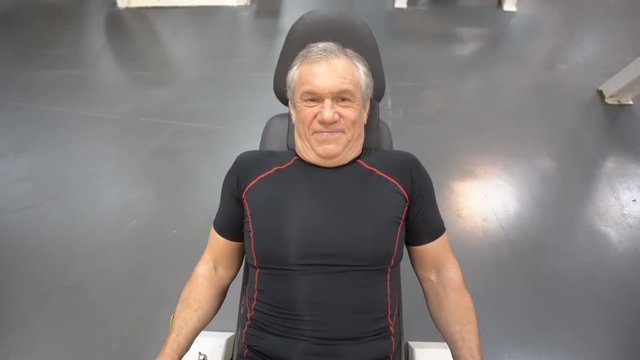 aged man in training on gym equipment
