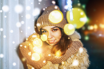 Pretty happy girl hold colorful lights in hands outdoor