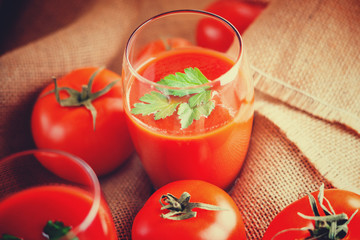 Glasses of fresh tomato juice and tomatoes 