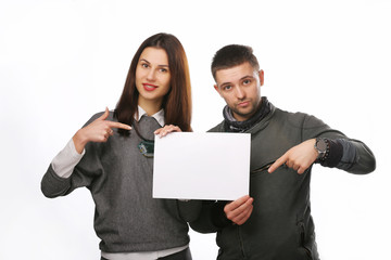 Young couple with a clean sheet on a white background. A man and a woman together. Empty place for text.