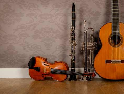 classical guitar, violin, clarinet and trumpet in vintage background