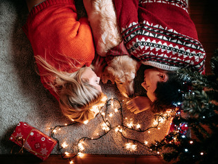 Christmas gifts and happiness between a young couple and a cute dog