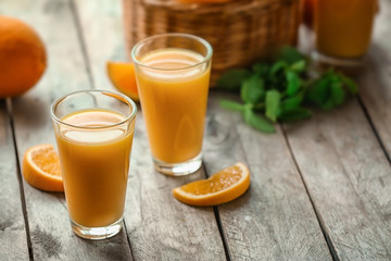 Glasses of fresh orange juice on table