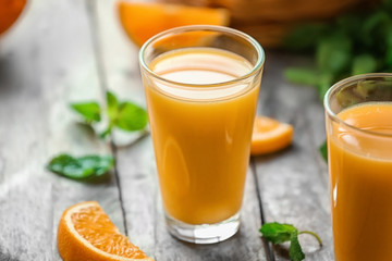 Glasses of fresh orange juice on table
