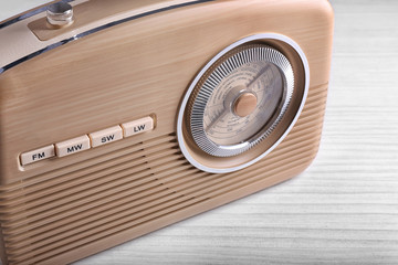 Stylish radio on wooden background