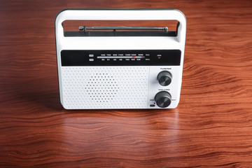 Modern radio on wooden background
