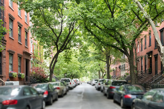 Tree Lined Street Of Historic Brownstone Buildings In A Greenwich Village Neighborhood In Manhattan New York City NYC