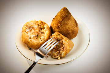 Sliced Arancino on a plate, typical rice Sicilian street food