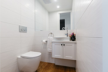 Fototapeta na wymiar Bright white contemporary powder room in an Australian home