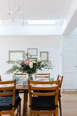 Dining table set for lunch with a large floral center piece