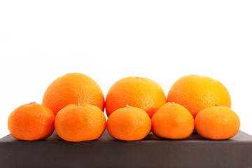 Group of small and big tangerines or mandarin oranges isolated on white