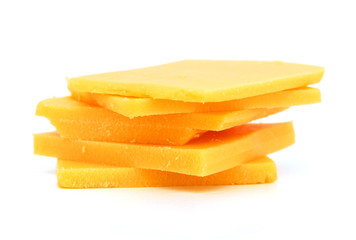 Naklejka na ściany i meble Cheddar cheese slices on white background.