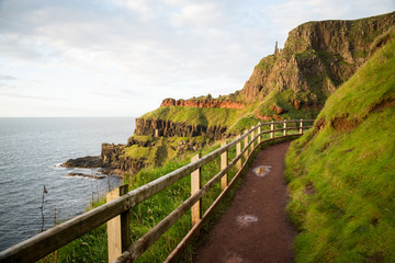 Fototapeta na wymiar A walkway in Ireland with the ocean and cliffs in the background. 