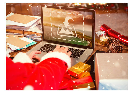 Santa Using Laptop Surrounded by Letters